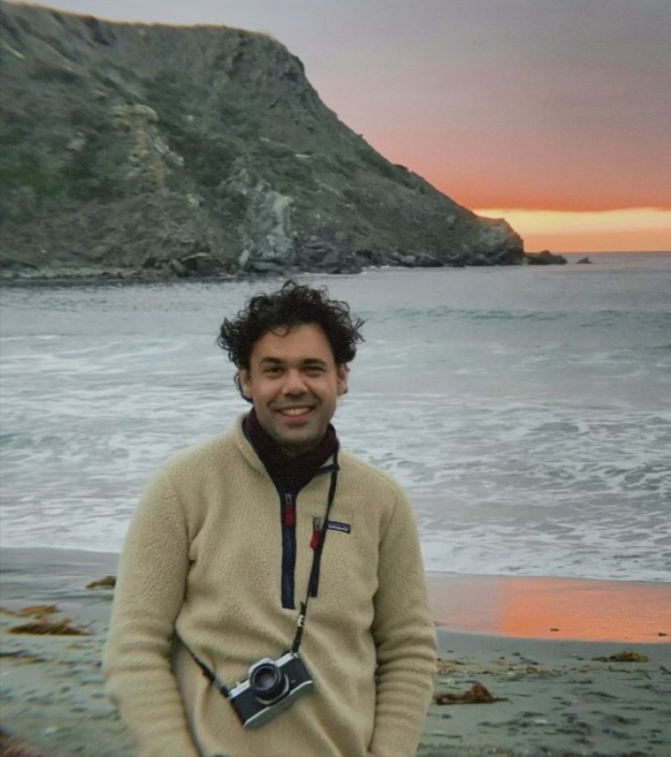 Paul Stavropoulos with a film camera on a beach